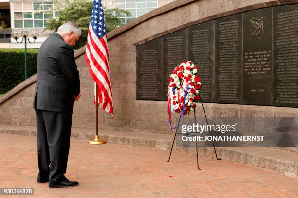 Secretary of State Rex Tillerson bows his head after laying a wreath at the 1998 U.S. Embassy bombing memorial site in Nairobi on March 11, 2018. /...