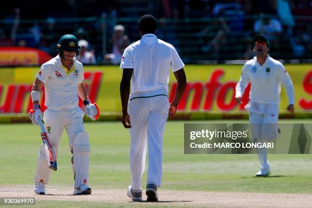 Australia's batsman David Warner leaves the ground after having been dismissed by South Africa bowler's Kagiso Rabada during day three of the second...