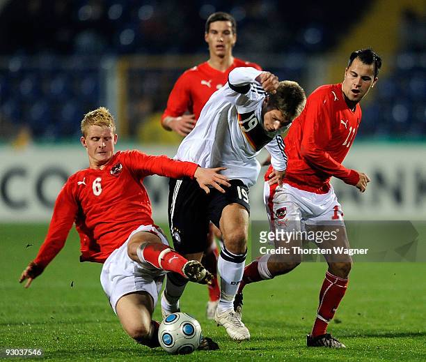 Alexander Esswein of Germany battles for the ball with Thomas Hopper and Leonhard Kaufmann of Austria during the U20 International Friendly match...