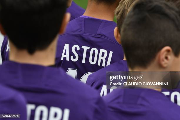 Children from both teams wear football jerseys number 13 to pay tribute to late Fiorentina's captain Davide Astori on March 11, 2018 before the...