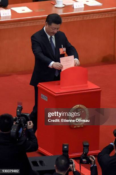 Chinese President Xi Jinping votes during the third plenary session of the first session of the 13th National People's Congress at The Great Hall of...