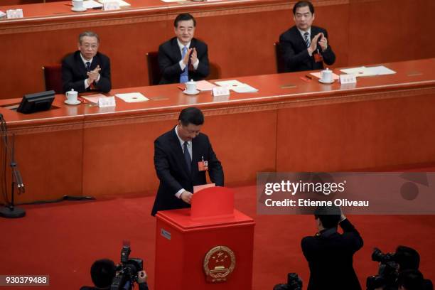 Chinese President Xi Jinping votes during the third plenary session of the first session of the 13th National People's Congress at The Great Hall of...