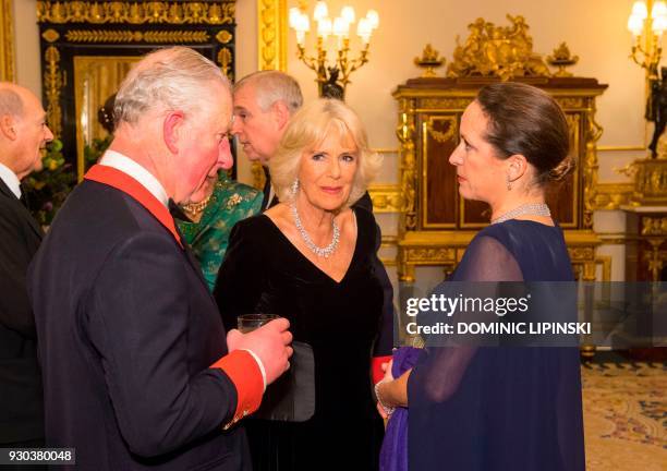 Britain's Prince Charles, Prince of Wales talks with Princess Zahra Aga Khan and Britain's Camilla, Duchess of Cornwall at Windsor Castle on March 8,...