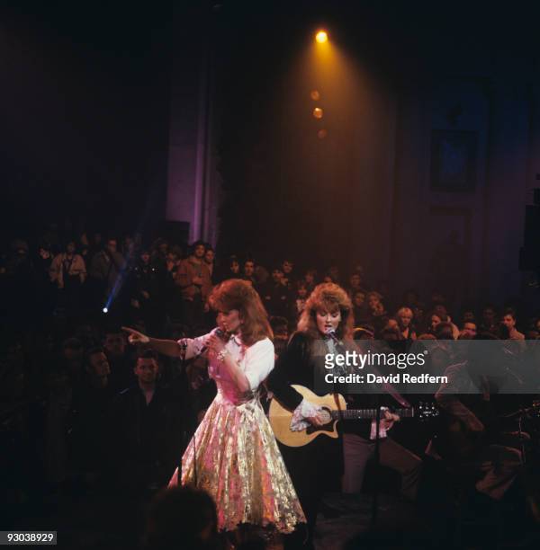Naomi and daughter Wynonna perform on stage as The Judds in 1989.
