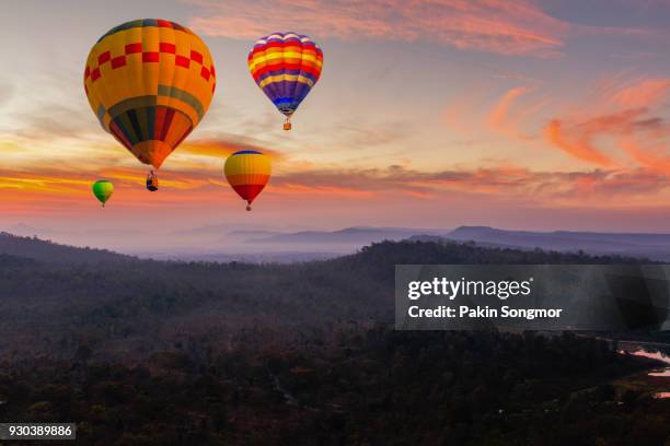 colorful hot air balloons flying over mountain at pakse. - hot air ballon foto e immagini stock