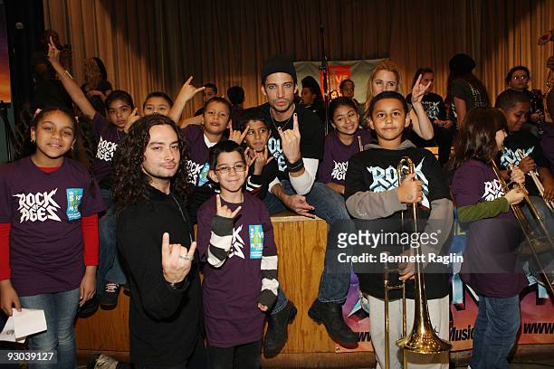 Constanine Maroulis, James Carpinello and Kerry Butler pose for a picture students from PS/IS 111 during visit PS/IS 111 on November 13, 2009 in New...