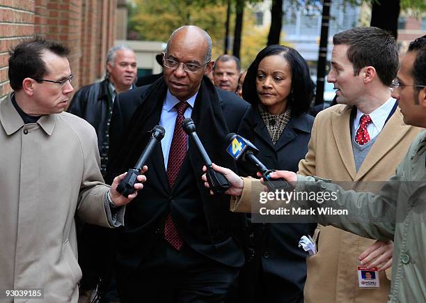Reporters follow former Congressman William Jefferson ) as he walks with his wife Andrea Jefferson while arriving at US District Court for his...