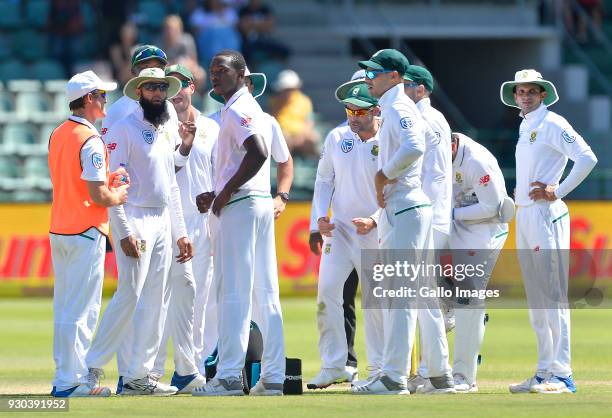 Kagiso Rabada and team mates of South Africa celebrate the wicket of David Warner of Australia during day 3 of the 2nd Sunfoil Test match between...