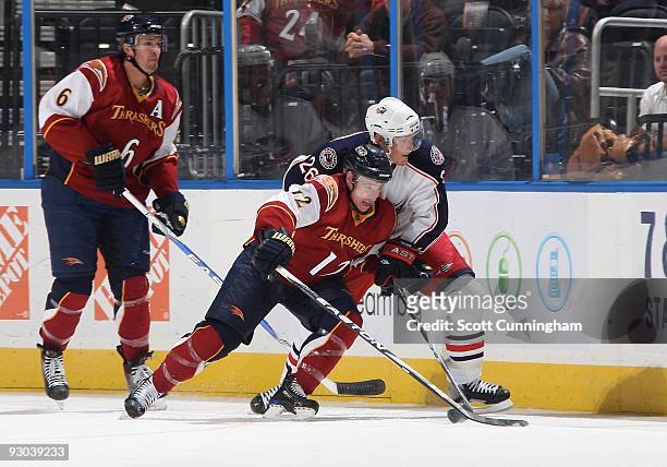 Todd White of the Atlanta Thrashers battles for the puck against Samuel Pahlsson of the Columbus Blue Jackets at Philips Arena on November 5, 2009 in...