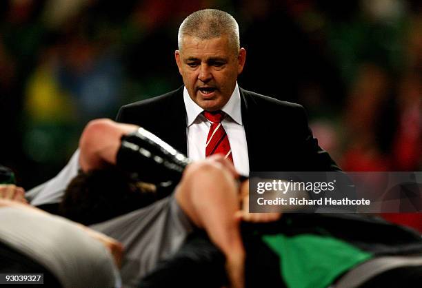 Wales head coach Warren Gatland talks to his players as they warm up during the Autumn International match between Wales and Samoa at Millennium...