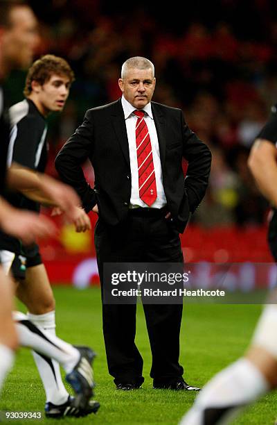 Wales head coach Warren Gatland talks to his players as they warm up during the Autumn International match between Wales and Samoa at Millennium...