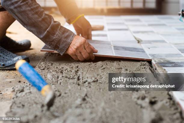 tiler and plaster - flooring installation stock pictures, royalty-free photos & images