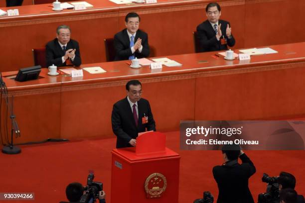 Chinese Premier Li Keqiang votes during the third plenary session of the first session of the 13th National People's Congress at The Great Hall of...