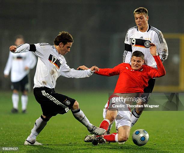Alexander Esswein and Fabian Becker of Germany battle for the ball with Juergen Prutsch of Austria during the U20 International Friendly match...