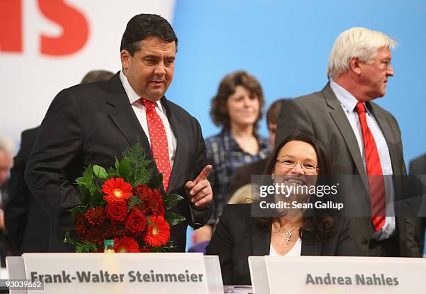 Sigmar Gabriel , new Chairman of the German Social Democratic Party , holds flowers for Andrea Nahles moments after she was elected SPD General...