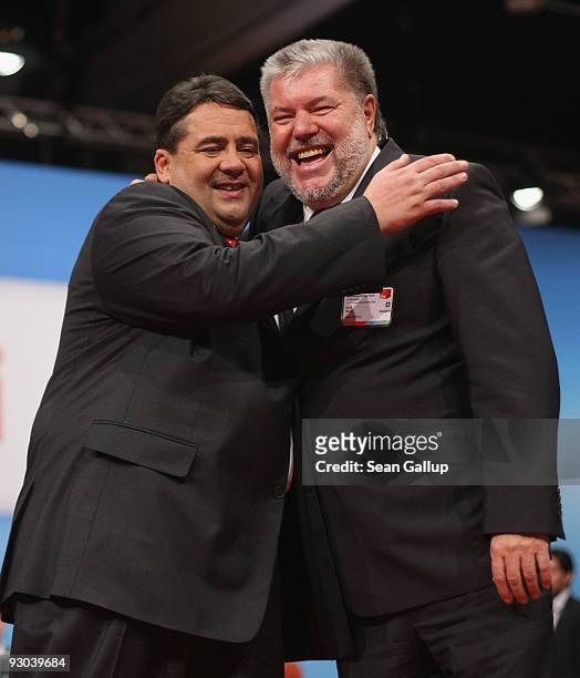 Sigmar Gabriel , newly elected Chairman of the German Social Democratic Party , embraces former SPD Chairman Kurt Beck at the SPD party congress on...