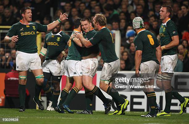 South Africa's captain John Smit is congratulated after scoring the opening try during the international match between France and South Africa at...
