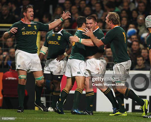 South Africa's captain John Smit is congratulated after scoring the opening try during the international match between France and South Africa at...