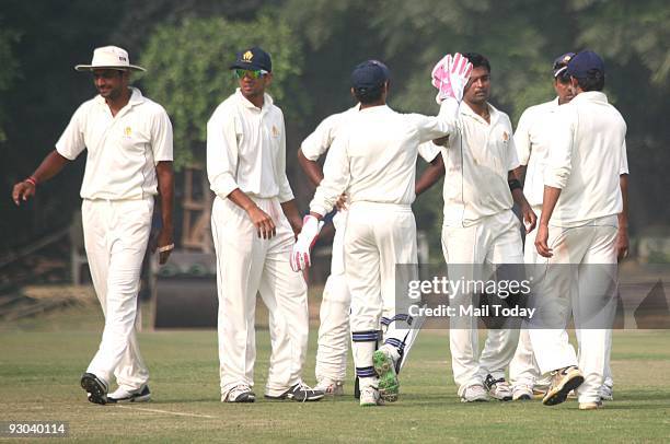 Captain of the Karnataka Ranji team Rahul Dravid celebrates a dismissal with his team at a Group B match of the Ranji Trophy Super League on Tuesday,...