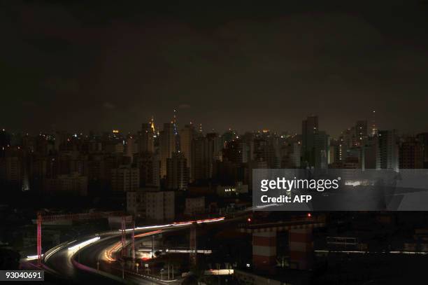 Residential buildings in the Moema neighborhood stand in darkness, the city lit solely by antennas atop buildings and vehicles headlights, during a...