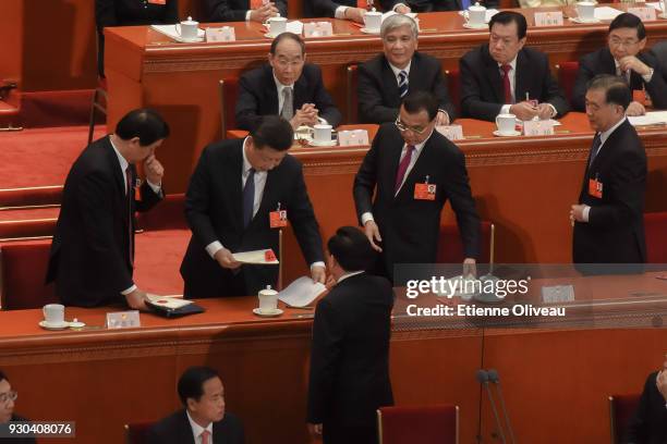 Chinese President Xi Jinping with National People's Congress Chairman Zhang Dejiang and Chinese Premier Li Keqiang leave the parliament after the...