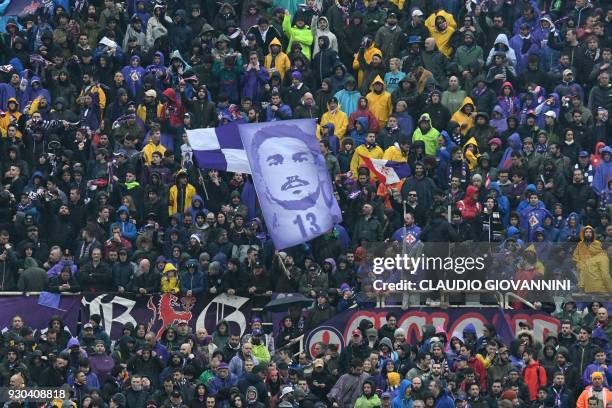 Fiorentina's hold a portrait of late captain Davide Astori during the Italian Serie A football match Fiorentina vs Benevento on March 11, 2018 at the...