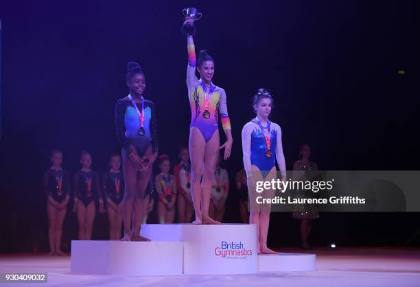 Amelie Morgan of The Academy recieves her gold medal for Vault alongside Ramiyah Kofi of Notts Gymnastics Academy and Scarlett Williams of Robin Hood...