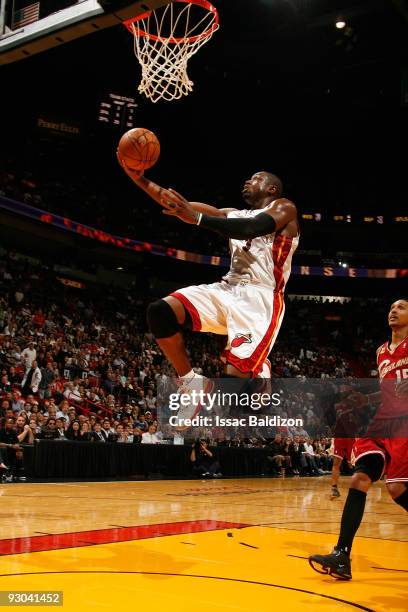 Dwyane Wade of the Miami Heat goes to the basket against the Cleveland Cavaliers during the game on November 12, 2009 at American Airlines Arena in...