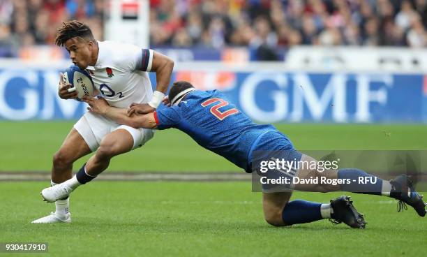 Anthony Watson of England is tackled by Guilhem Guirado during the NatWest Six Nations match between France and England at Stade de France on March...