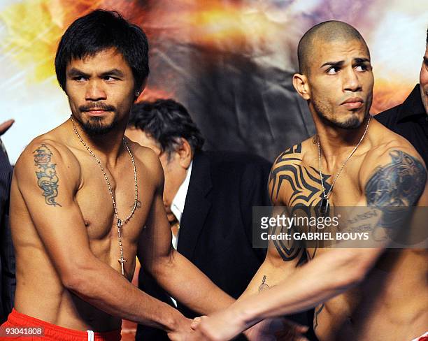 Welterweight boxing champion Manny "PacMan" Pacquiao of the Philippines poses during the official weigh-in for his fight against WBO champion Miguel...