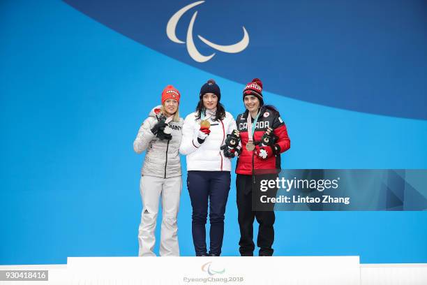 Silver Medalist Andrea Rothfuss of Germany, Gold Medalist Marie Bochet of France and Bronze Medalist Alana Ramsay of Canada pose during the victory...