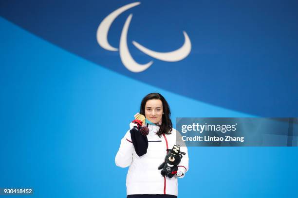 Gold Medalist Marie Bochet of France celebrate during the victory ceremony of the Women's Super-G Standing Alpine Skiing during day two of the...