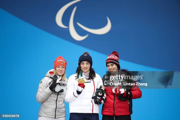 Silver Medalist Andrea Rothfuss of Germany, Gold Medalist Marie Bochet of France and Bronze Medalist Alana Ramsay of Canada pose during the victory...