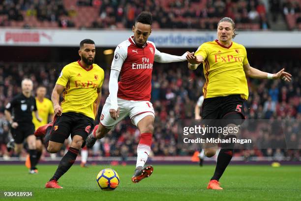 Pierre-Emerick Aubameyang of Arsenal misses a chance under pressure from Sebastian Prodl of Watford during the Premier League match between Arsenal...