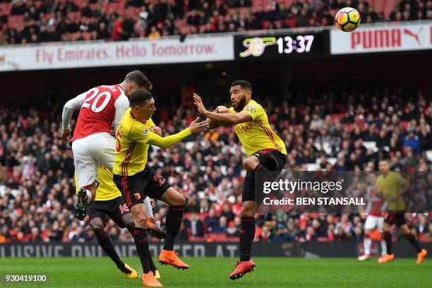 Arsenal's German defender Shkodran Mustafi heads the opening goal of the English Premier League football match between Arsenal and Watford at the...