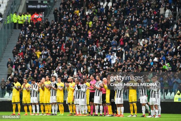 Players and referees respect one minute of silence for Fiorentina's captain Davide Astori before the Italian Serie A football match Juventus vs...