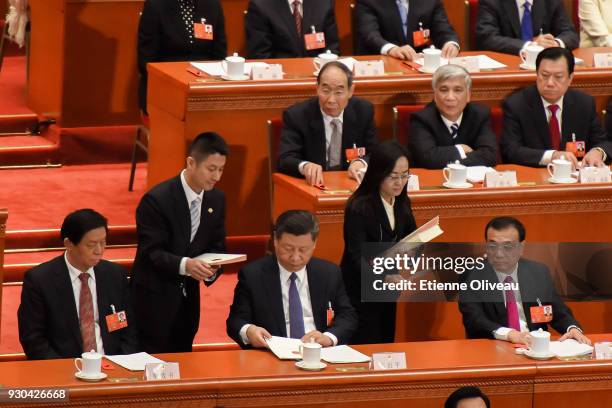 Chinese President Xi Jinping with National People's Congress Chairman Zhang Dejiang and Chinese Premier Li Keqiang examine their ballot during the...