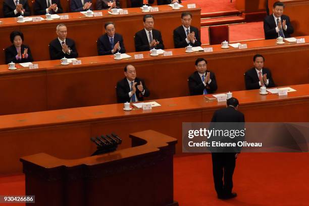 Chairman of the Standing Committee of the National People's Congress Zhang Dejiang bends to Chinese President Xi Jinping prior to his speech and...