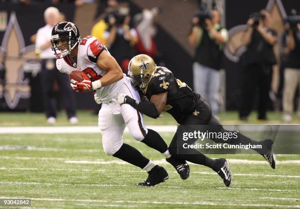 Tony Gonzalez of the Atlanta Falcons runs with a catch against Roman Harper of the New Orleans Saints at the Louisiana Superdome on November 2, 2009...