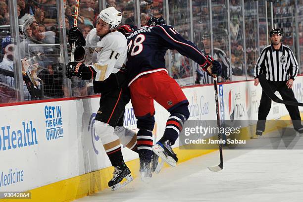 Umberger of the Columbus Blue Jackets finishes a check on Joffrey Lupul of the Anaheim Ducks during the first period on November 13, 2009 at...