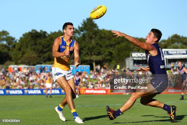 Thomas Cole of the Eagles handballs against Bailey Banfield of the Dockers during the JLT Community Series AFL match between the Fremantle Dockers...