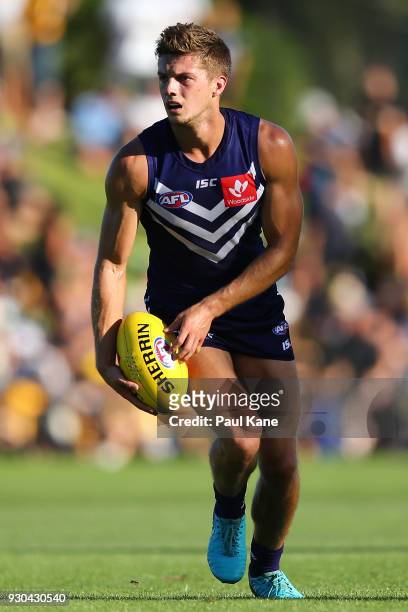 Darcy Tucker of the Dockers looks to pass the ball during the JLT Community Series AFL match between the Fremantle Dockers and the West Coast Eagles...
