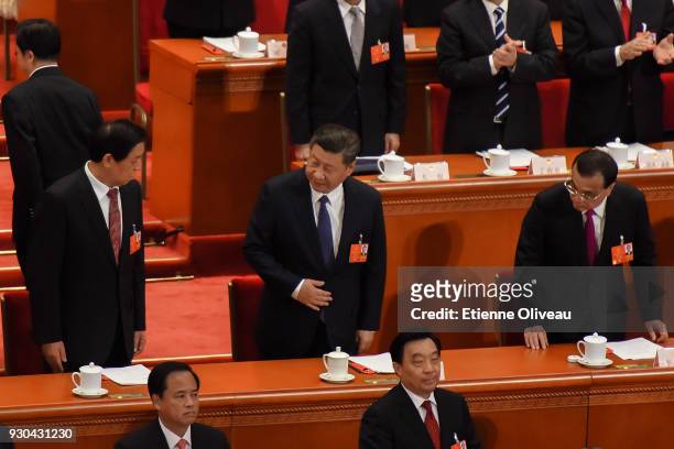 Chinese President Xi Jinping , National People's Congress Chairman Zhang Dejiang and Chinese Premier Li Keqiang take their seats during the third...