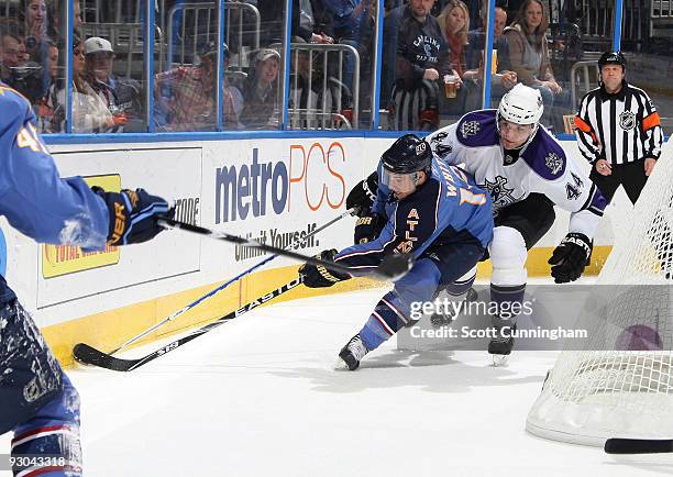 Todd White of the Atlanta Thrashers battles for the puck against Anze Kopitar of the Los Angeles Kings at Philips Arena on November 13, 2009 in...