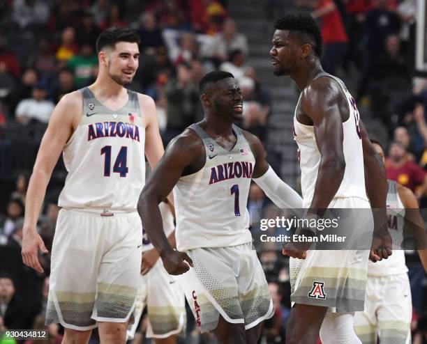 Dusan Ristic, Rawle Alkins and Deandre Ayton of the Arizona Wildcats celebrate on the court after Alkins and then Ayton dunked against the USC...