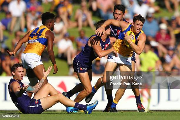 Jack Redden of the Eagles looks to break from a tackle during the JLT Community Series AFL match between the Fremantle Dockers and the West Coast...