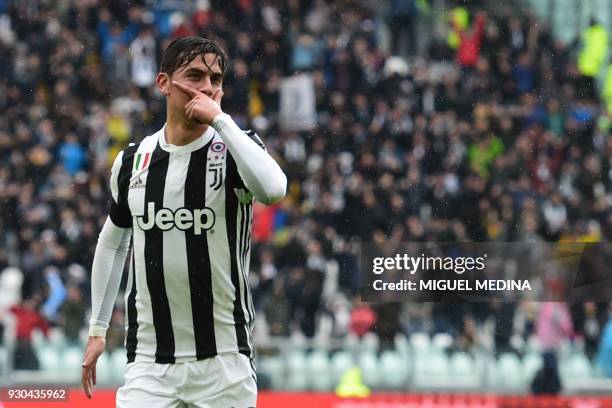 Juventus' forward from Argentina Paulo Dybala celebrates after scoring during the Italian Serie A football match Juventus vs Udinese on March 11,...