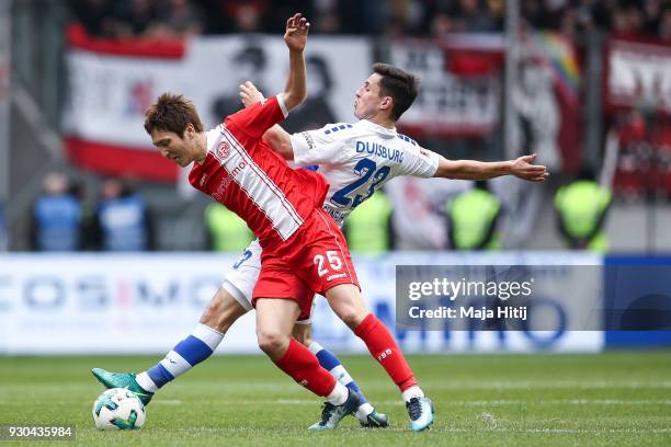 Fabian Schnellhardt of MSV Duisburg and Genki Haraguchi of Fortuna Duesseldorf battle for the ball during the Second Bundesliga match between MSV...