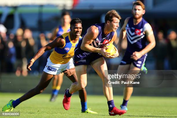 Lee Spurr of the Dockers looks to handball during the JLT Community Series AFL match between the Fremantle Dockers and the West Coast Eagles at HBF...