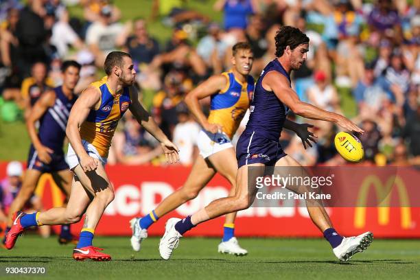 Alex Pearce of the Dockers passes the ball during the JLT Community Series AFL match between the Fremantle Dockers and the West Coast Eagles at HBF...